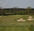 The par-3 16th hole on The Duke's Course heads downhill from the tee box and plays to a large green. 
