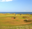 Kingsbarns Golf Links' first hole doglegs right to a green sitting out near the sea.